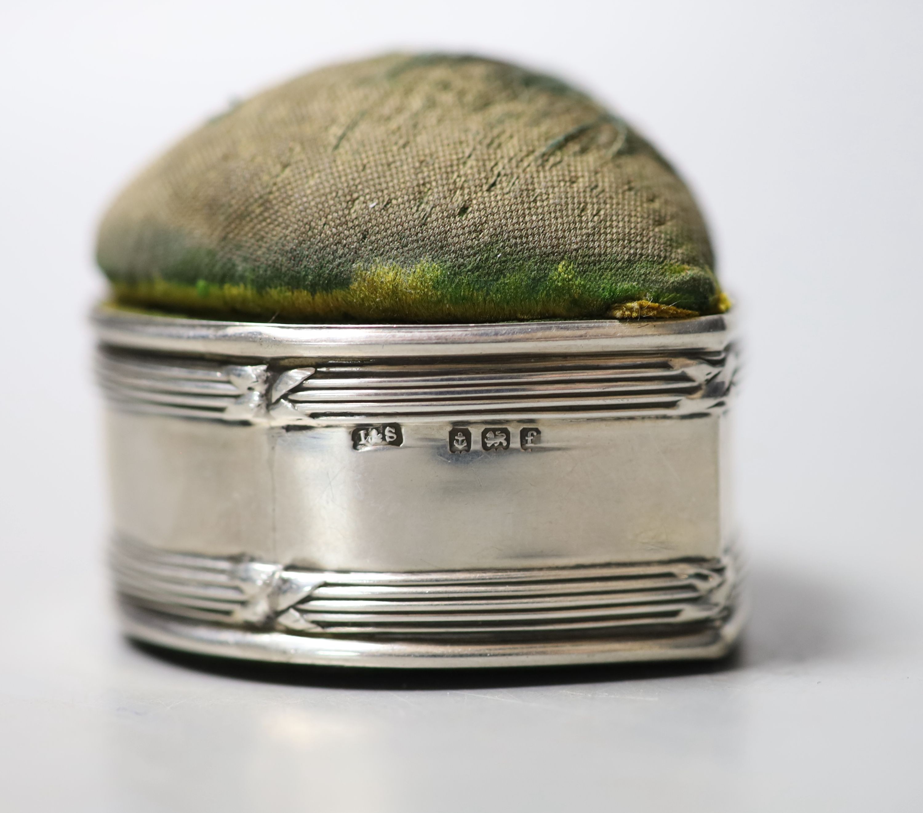 An Edwardian silver mounted heart shaped pin cushion, Birmingham, 1905, 52mm and a filigree white metal card case, 12.1cm.